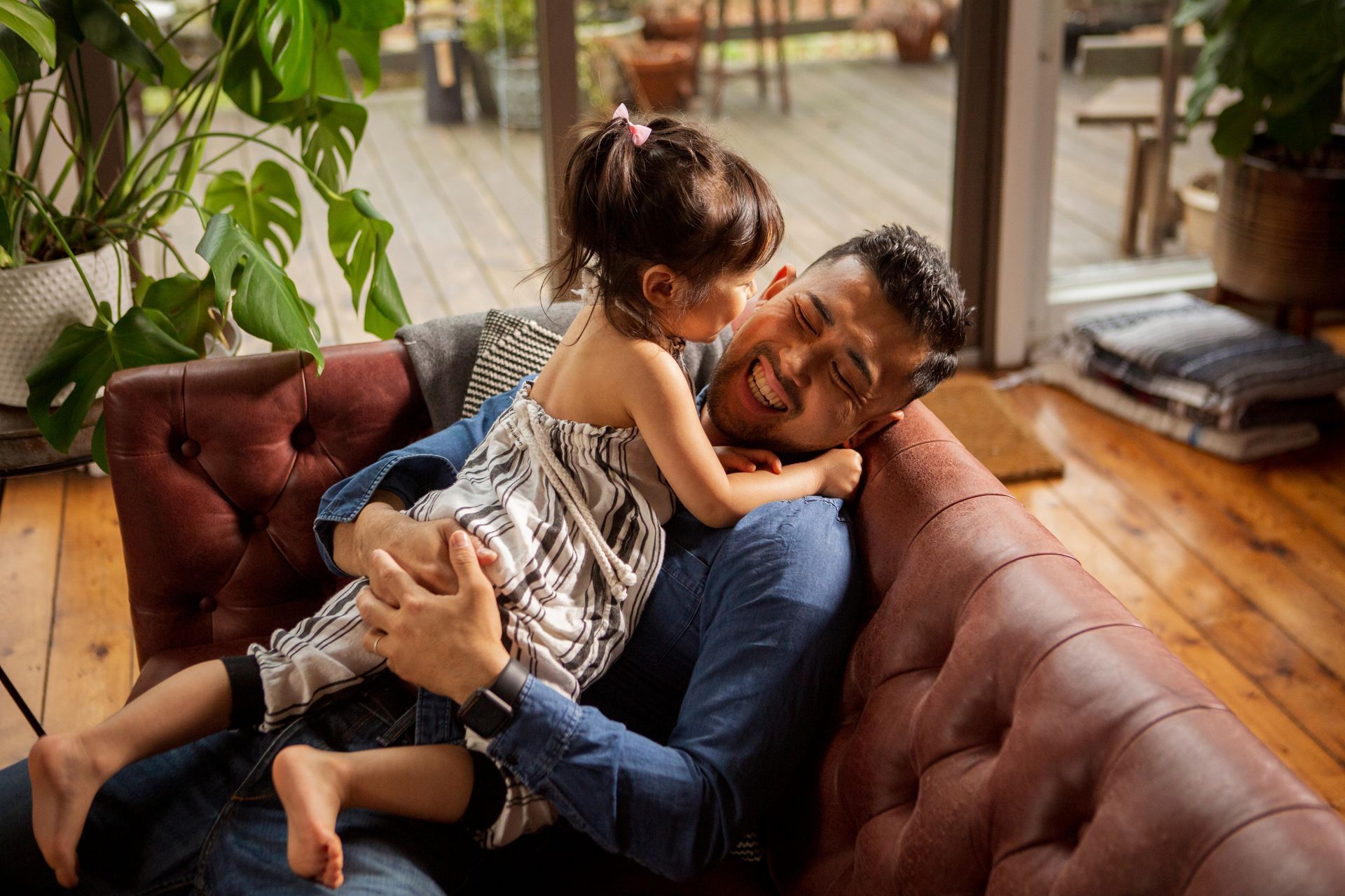 A man and a little girl are sitting on a couch at The Winchester