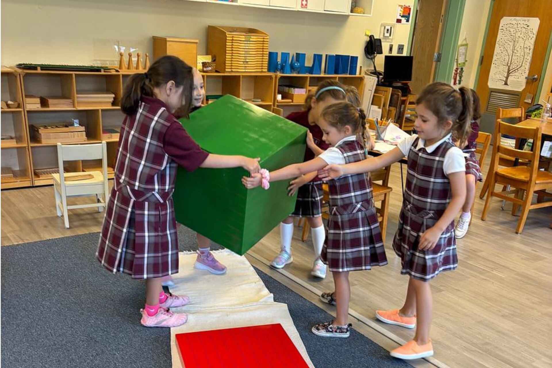 Montessori children playing together, learning empathy, cooperation, and friendship skills.
