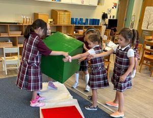 Montessori children playing, learning empathy, cooperation, and friendship skills.