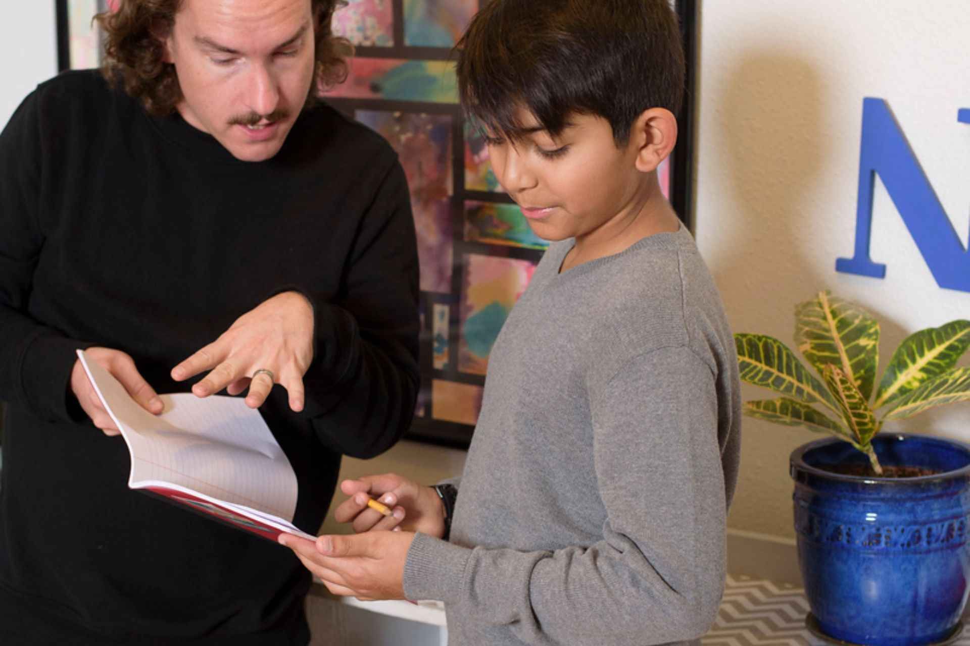 Montessori guide and child reflect together during a one-on-one conference