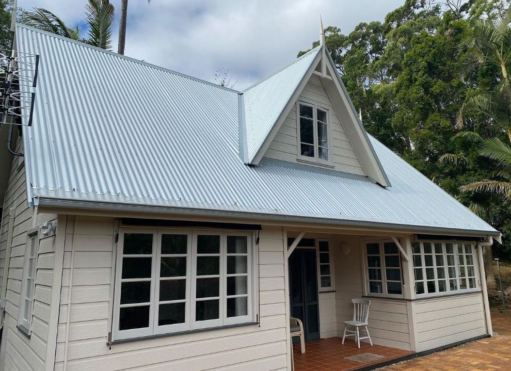 A White House With a Blue Roof and Many Windows  — Northern Rivers Metal Roofing PTY LTD In Alstonville, NSW