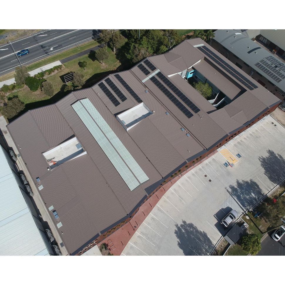 An Aerial View of a Large Building With Solar Panels on the Roof — Northern Rivers Metal Roofing PTY LTD In Pottsville, NSW