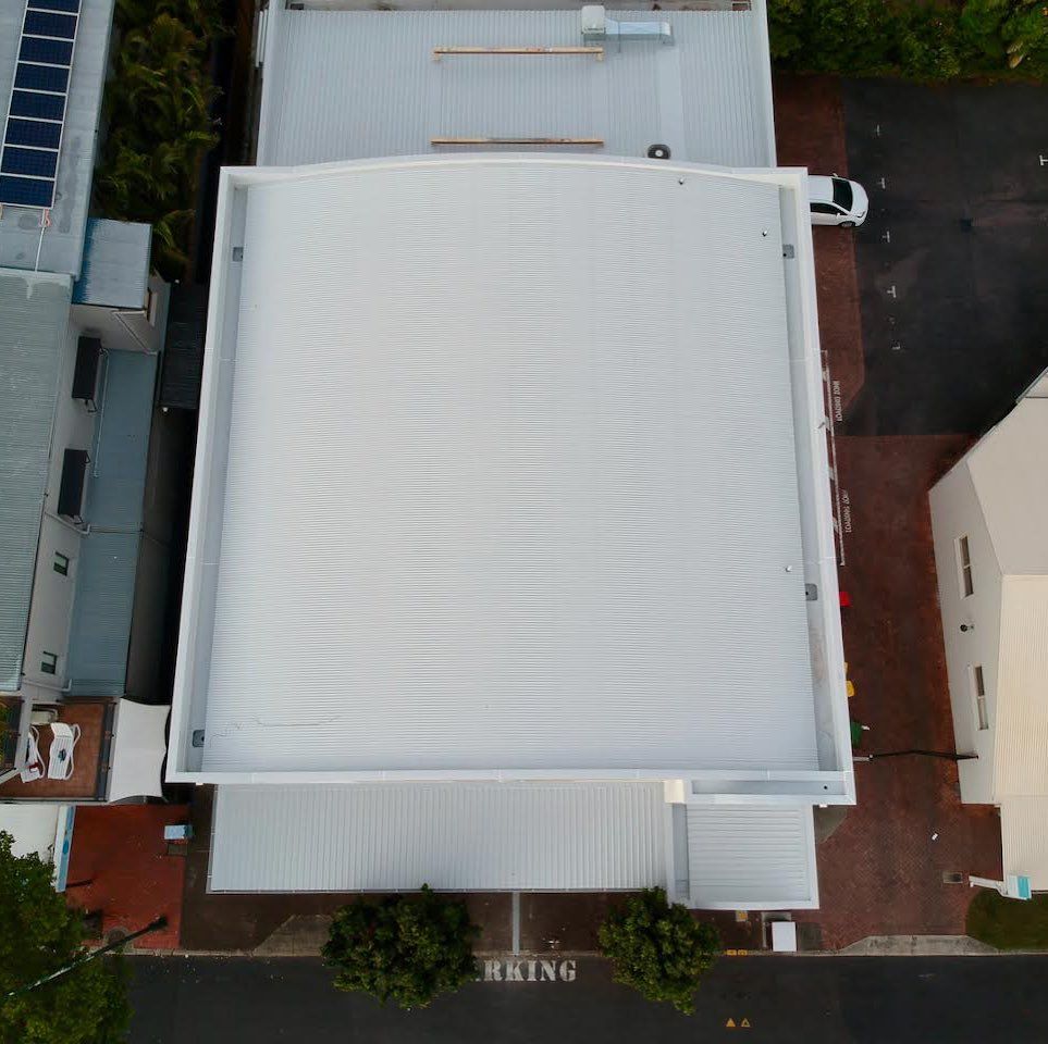 An Aerial View of a Building With a White Roof — Northern Rivers Metal Roofing PTY LTD In Pottsville, NSW