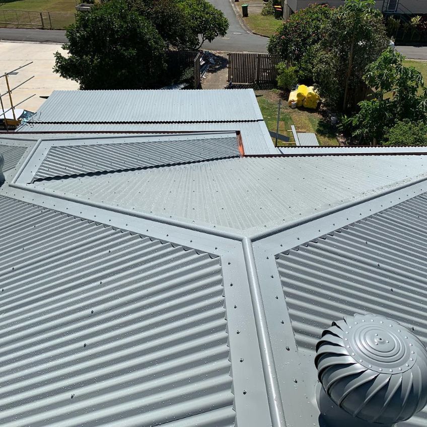 An Aerial View of a Roof With a Wind Turbine on It — Northern Rivers Metal Roofing PTY LTD In Byron Bay, NSW