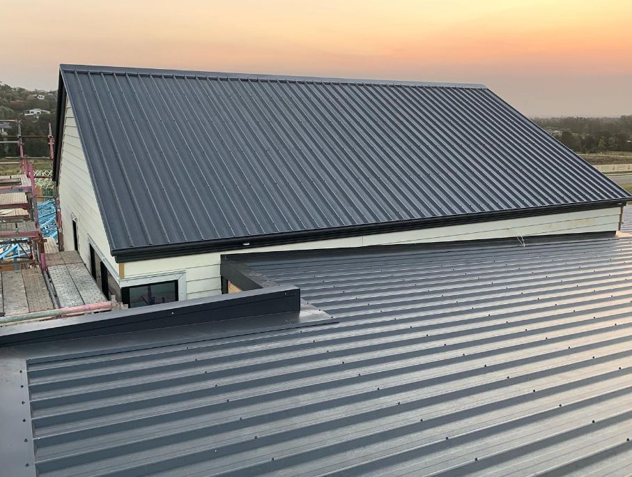 A House With a Black Metal Roof is Being Built — Northern Rivers Metal Roofing PTY LTD In Brunswick Heads, NSW