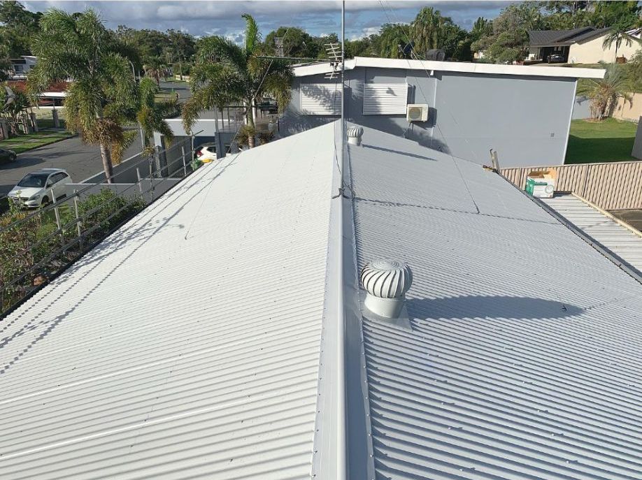 A White Roof With a Wind Turbine on Top of It — Northern Rivers Metal Roofing PTY LTD In Murwillumbah, NSW