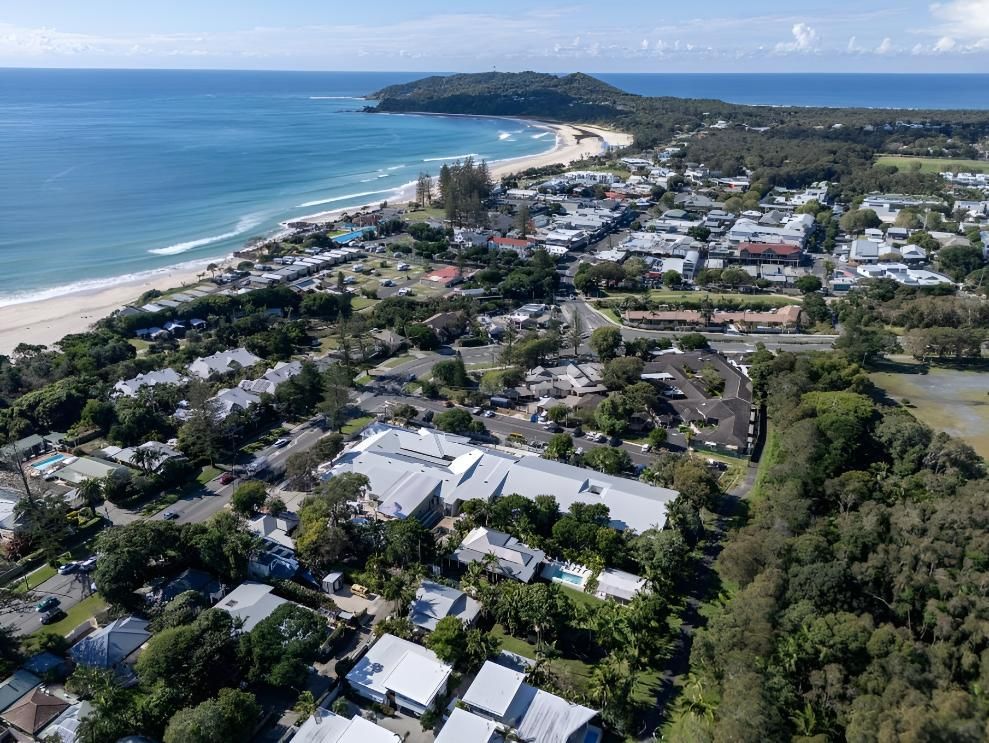 Coastal Town With a Beach, Buildings, and Green Trees — Northern Rivers Metal Roofing PTY LTD In Byron Bay, NSW