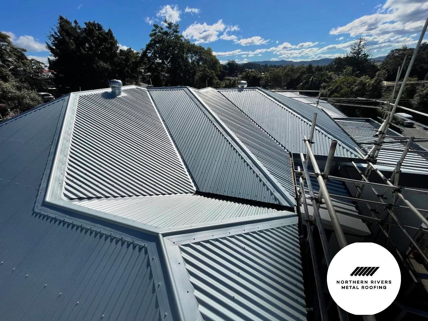 A Metal Roof With Scaffolding on Top — Northern Rivers Metal Roofing PTY LTD In Ewingsdale, NSW