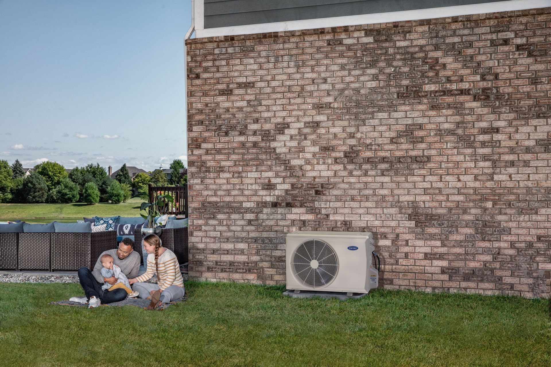 A row of air conditioners on the side of a house