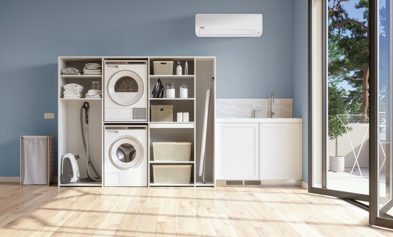 A laundry room with a washer and dryer stacked on top of each other.