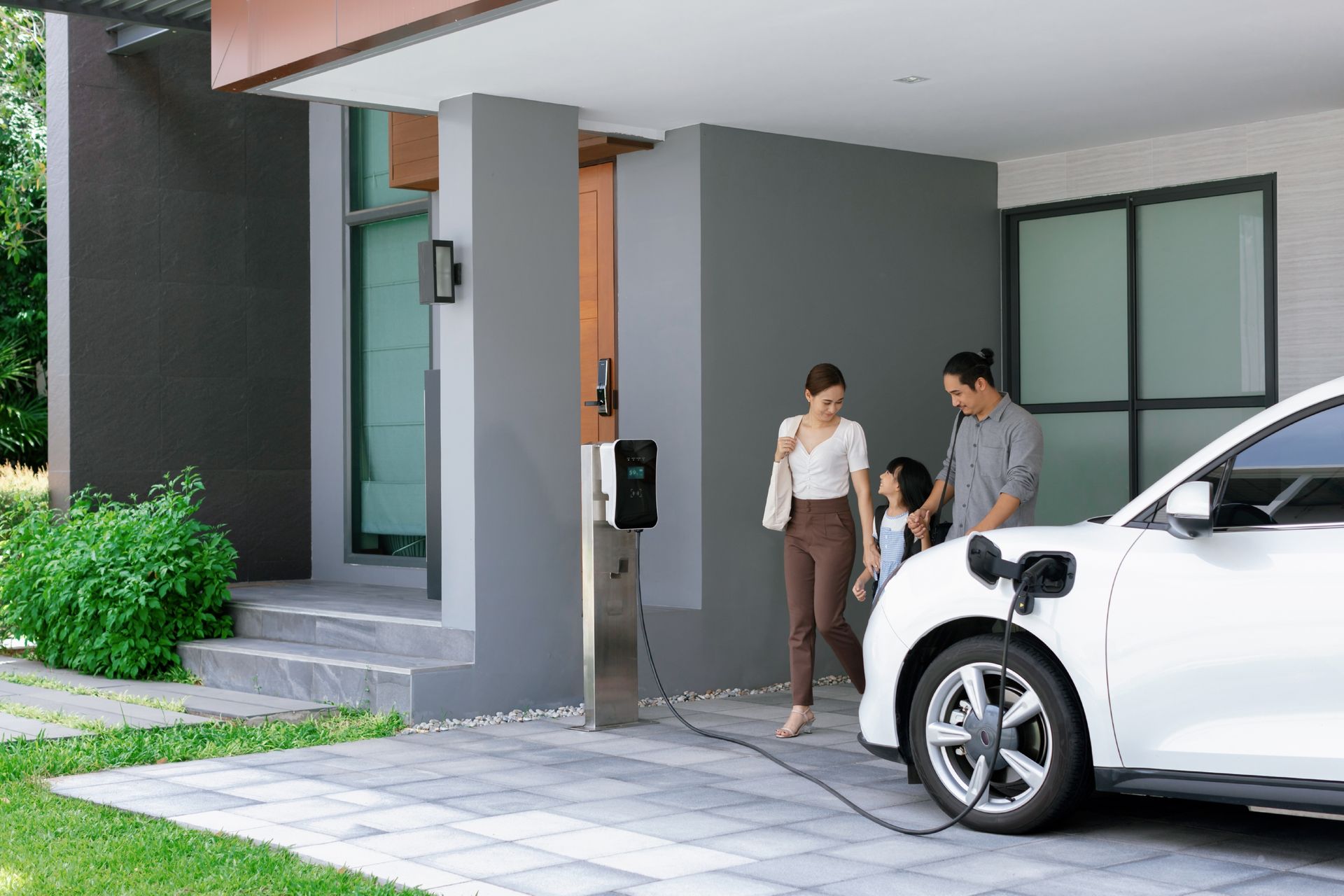 two electric vehicle charging stations are sitting in front of a building .