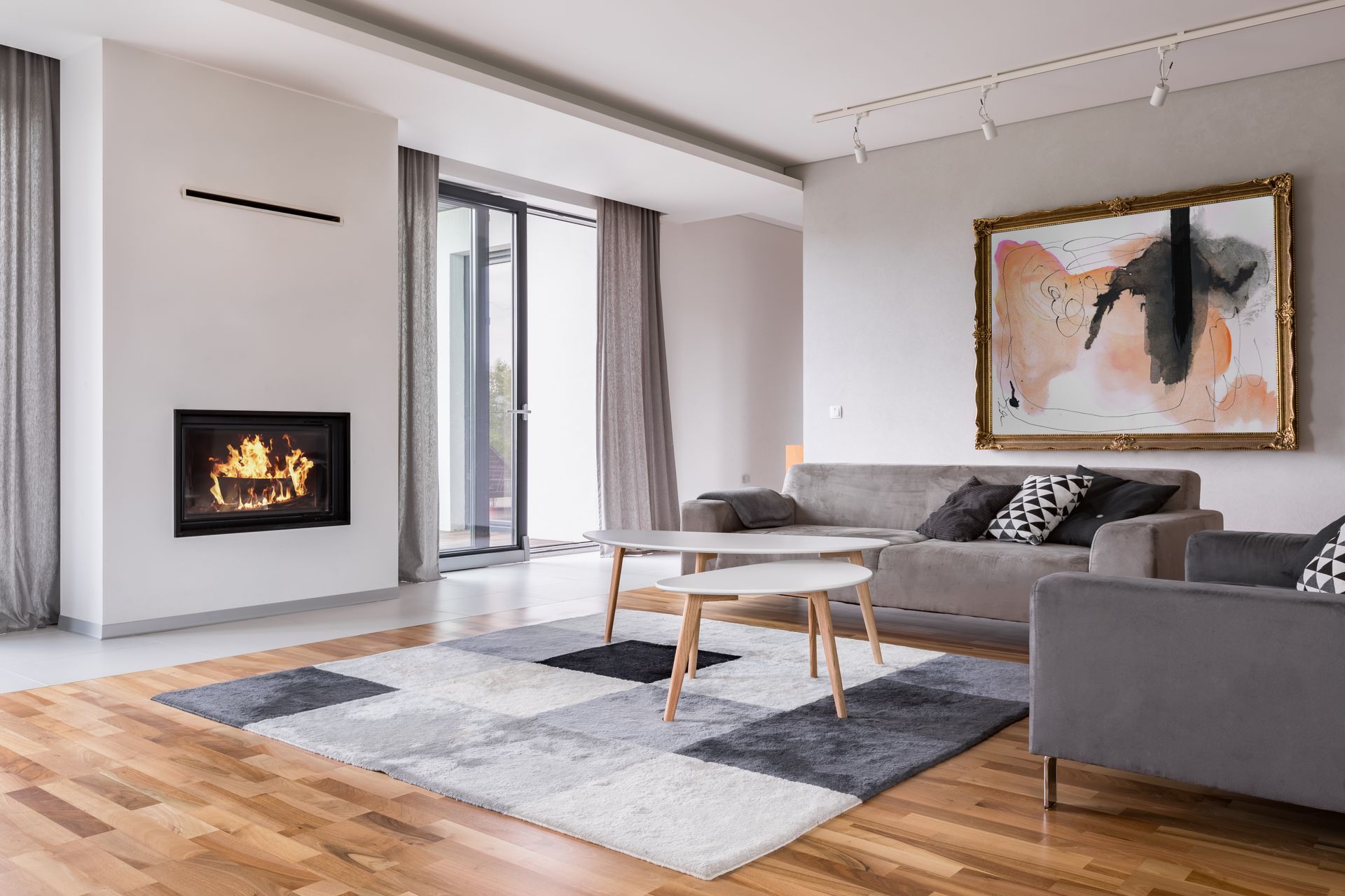 A living room with a fireplace , couch , chairs and a rug.