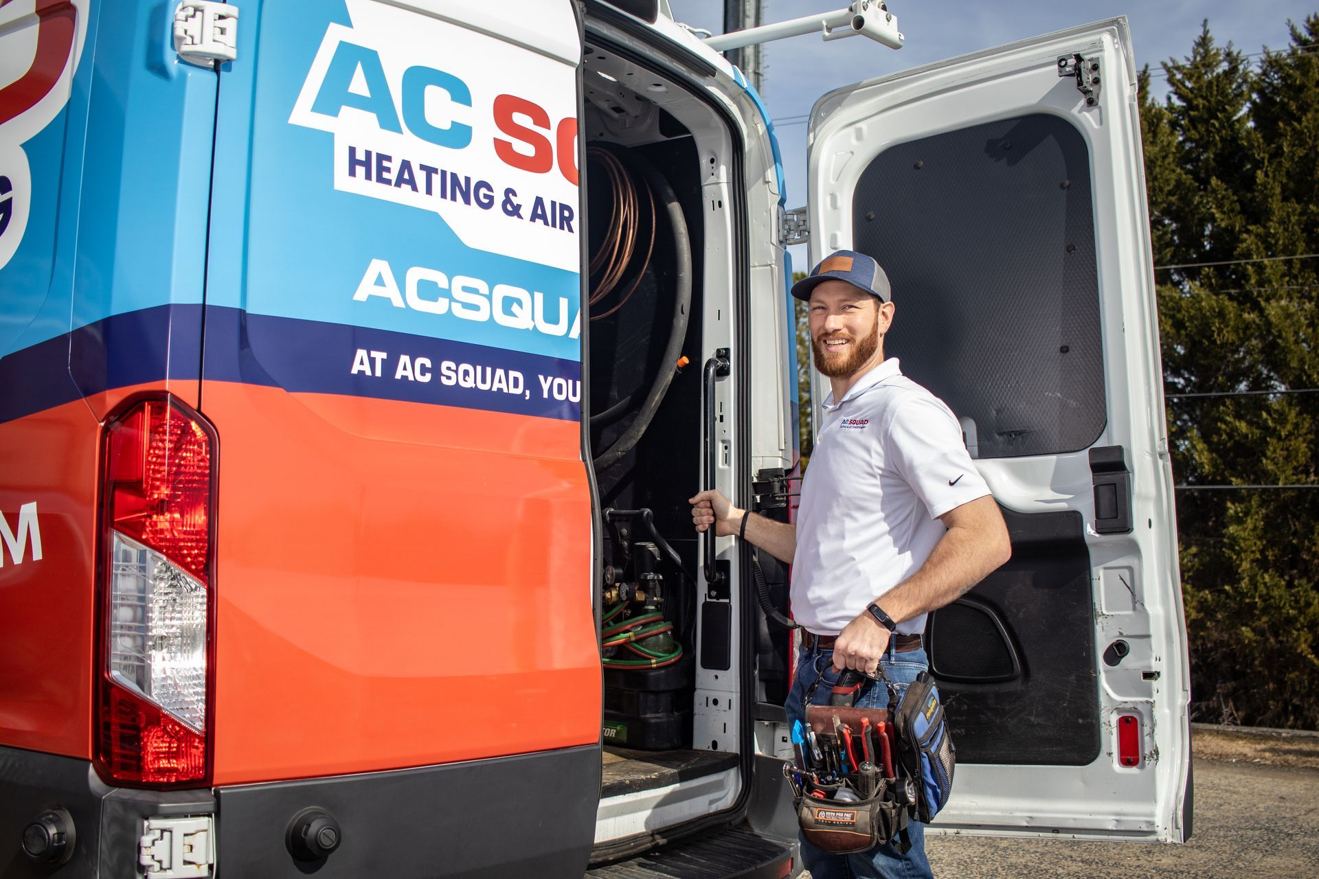 A man is fixing an air conditioner with a multimeter.