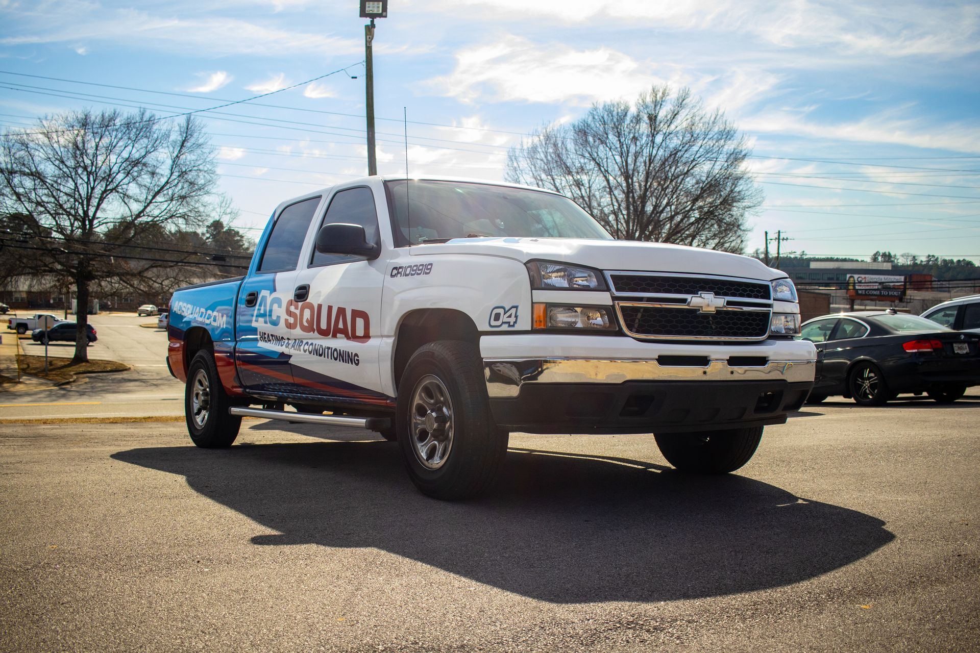 A man and a woman are sitting on a couch looking at a tablet.