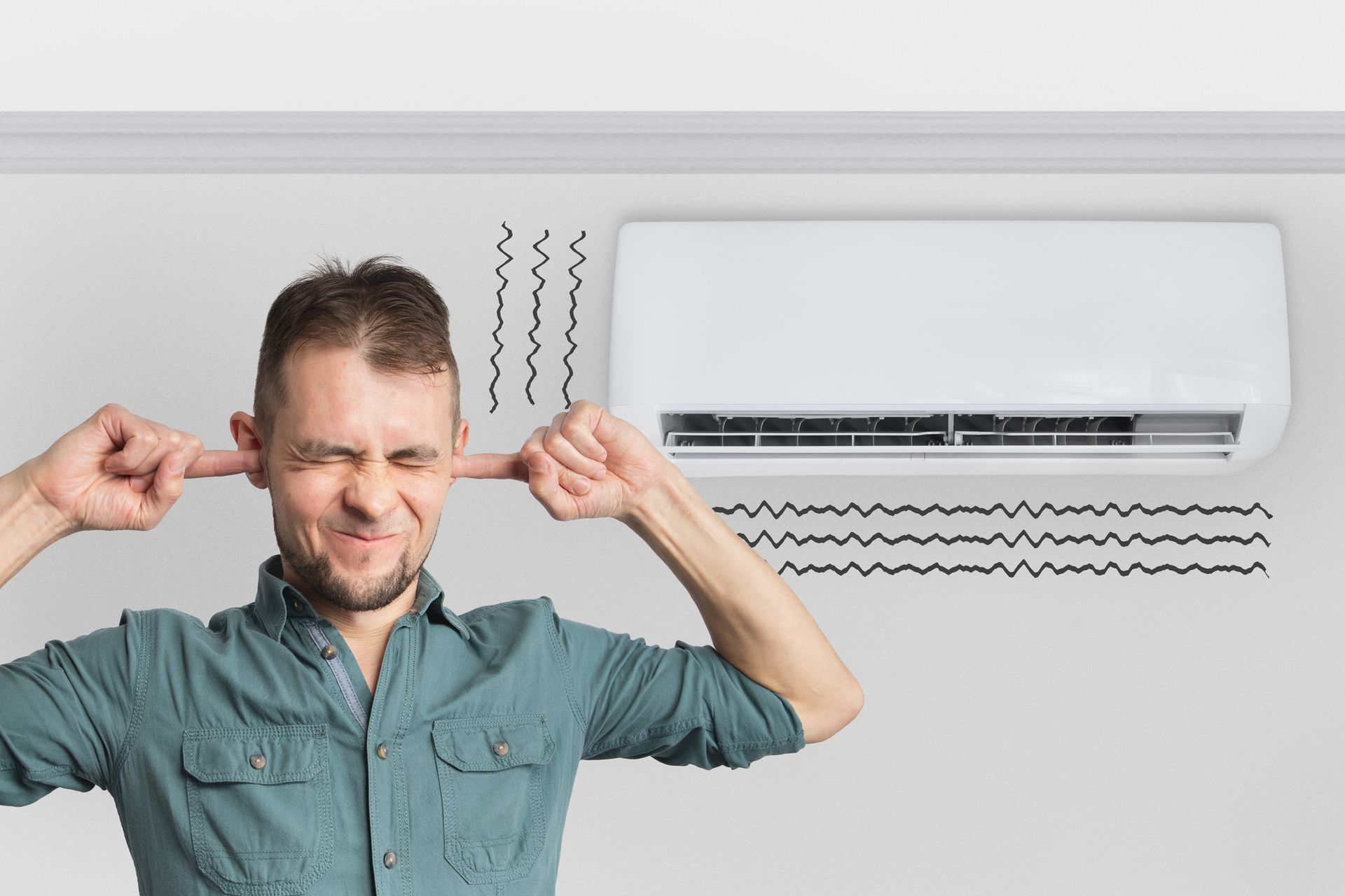 The air conditioner is broken - makes loud noises, noises and vibrations. Man covering his ears.