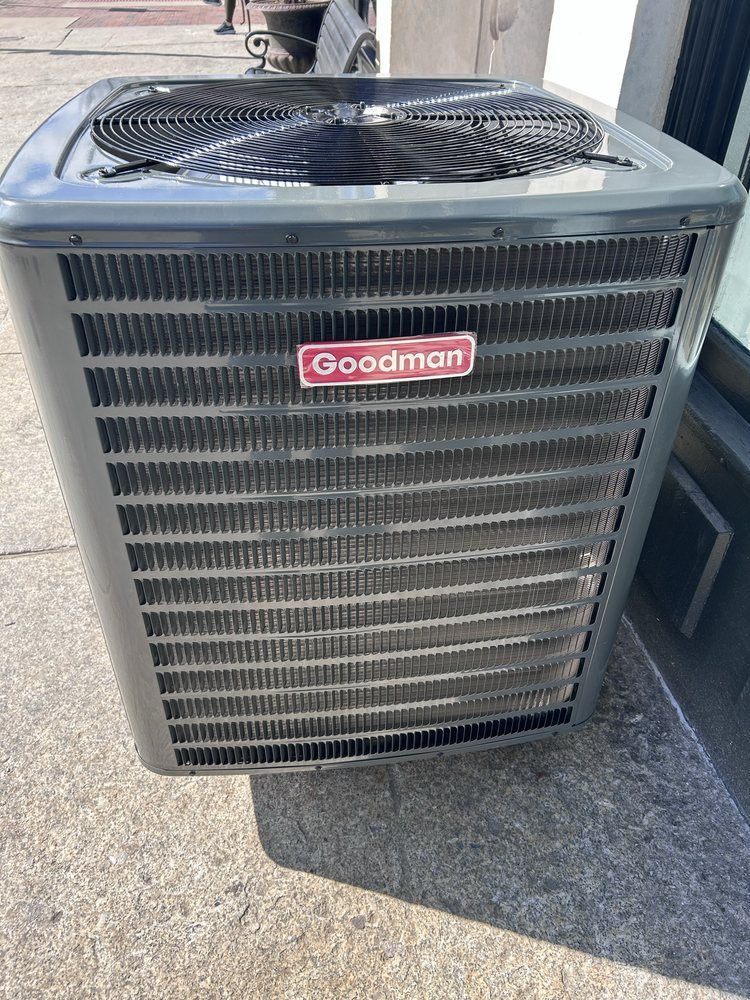 Gray Goodman air conditioner unit outside.