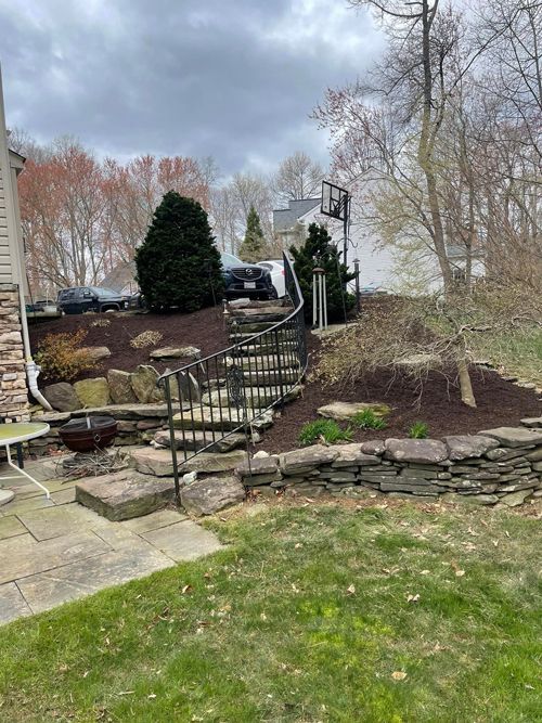A Set Of Stairs Leading Up To A House In A Backyard - Perry Hall, MD - Oakwood Landscaping LLC