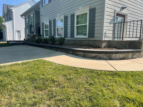 A Large House With A Concrete Walkway And A Large Lawn In Front Of It - Perry Hall, MD - Oakwood Landscaping LLC