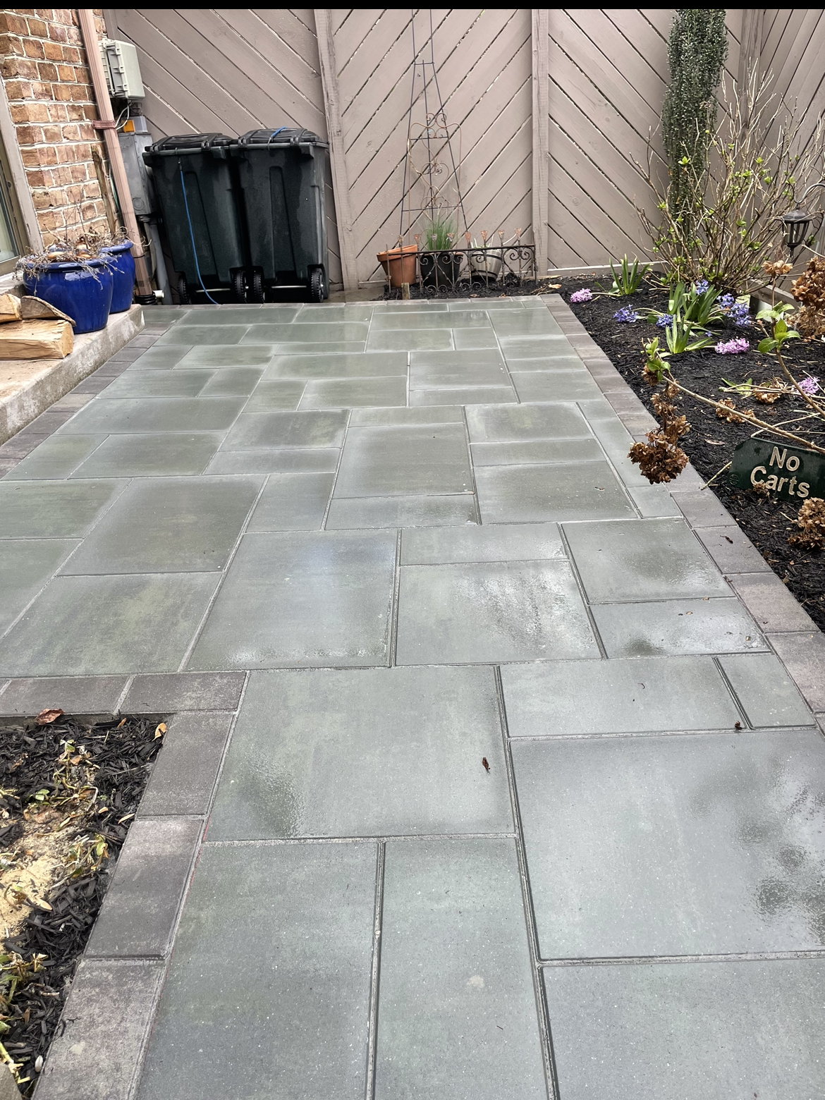 A Backyard With A Deck And A House In The Background - Perry Hall, MD - Oakwood Landscaping LLC