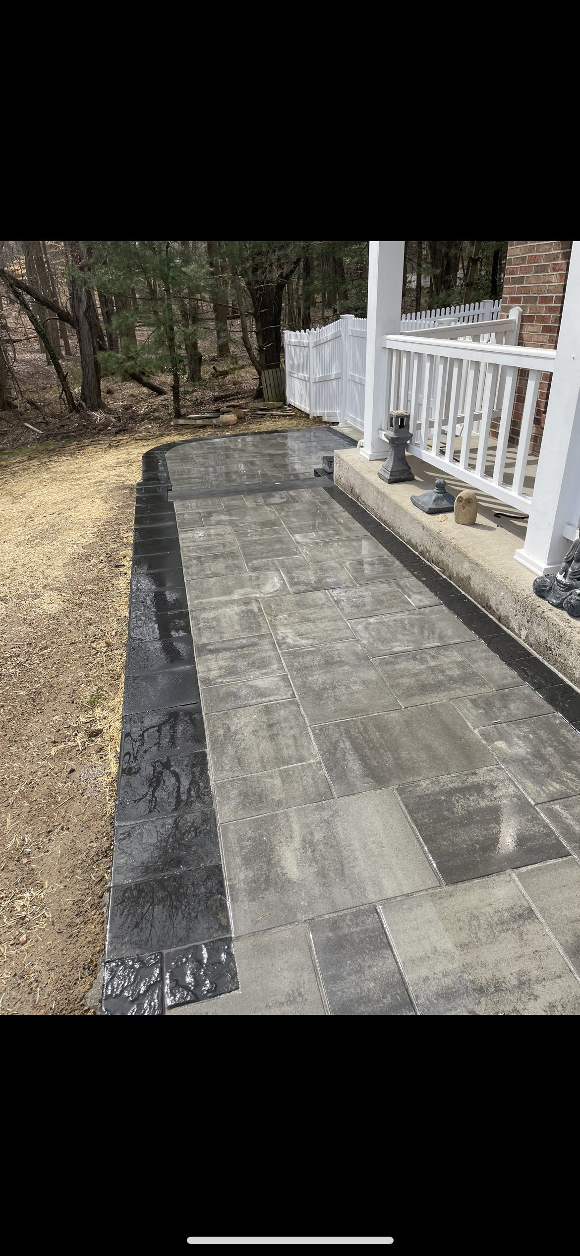 A Concrete Walkway Leading To A House With A Lush Green Lawn - Perry Hall, MD - Oakwood Landscaping LLC