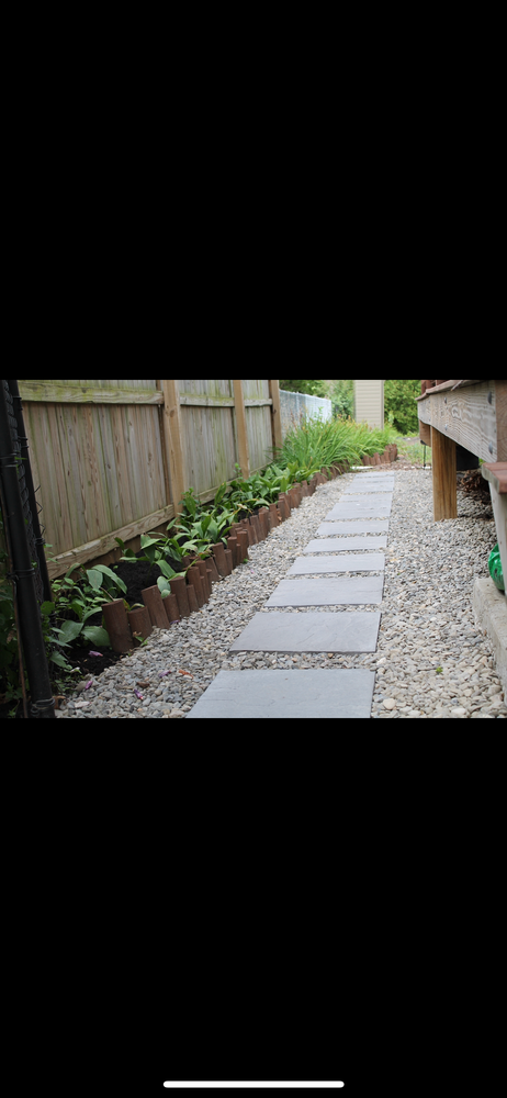 A Stone Walkway Leading To A Fence In A Backyard - Perry Hall, MD - Oakwood Landscaping LLC