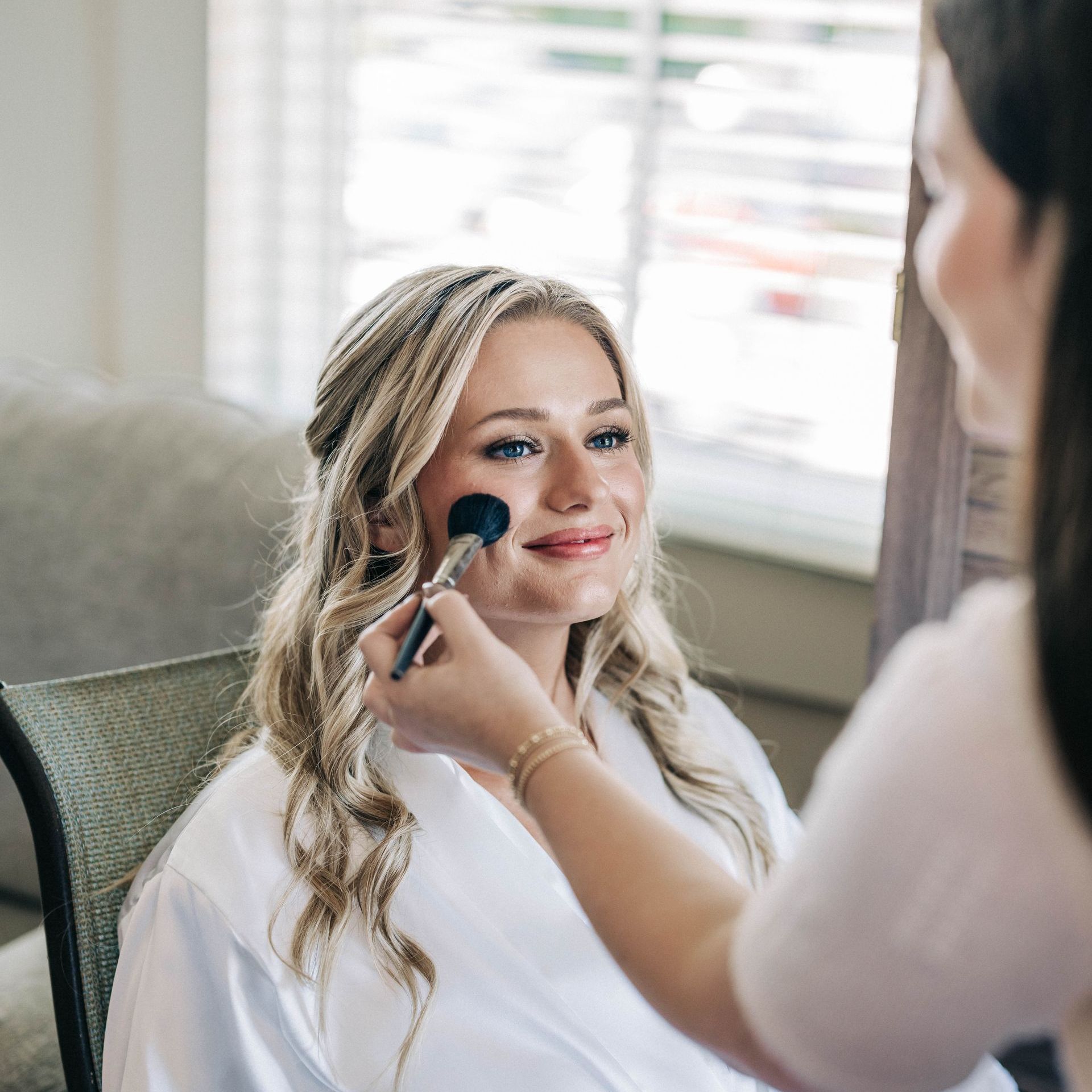 Picture of Kate Scullen applying makeup to a client