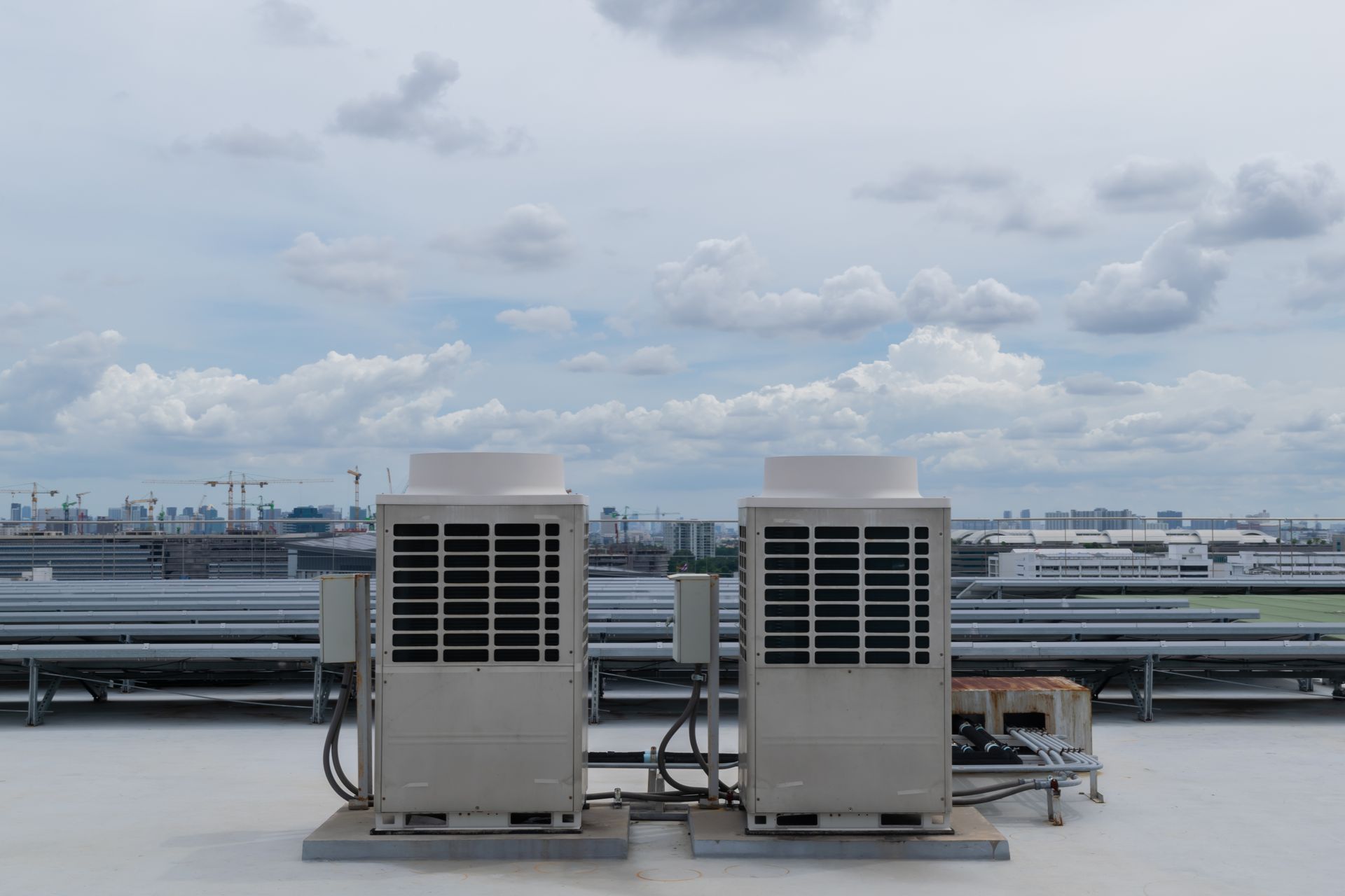 Image shows Industrial size HVAC systems on a rooftop.