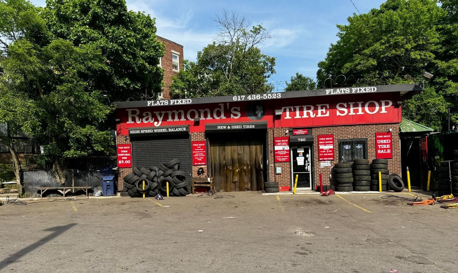 A man is working on a tire in a tire shop.