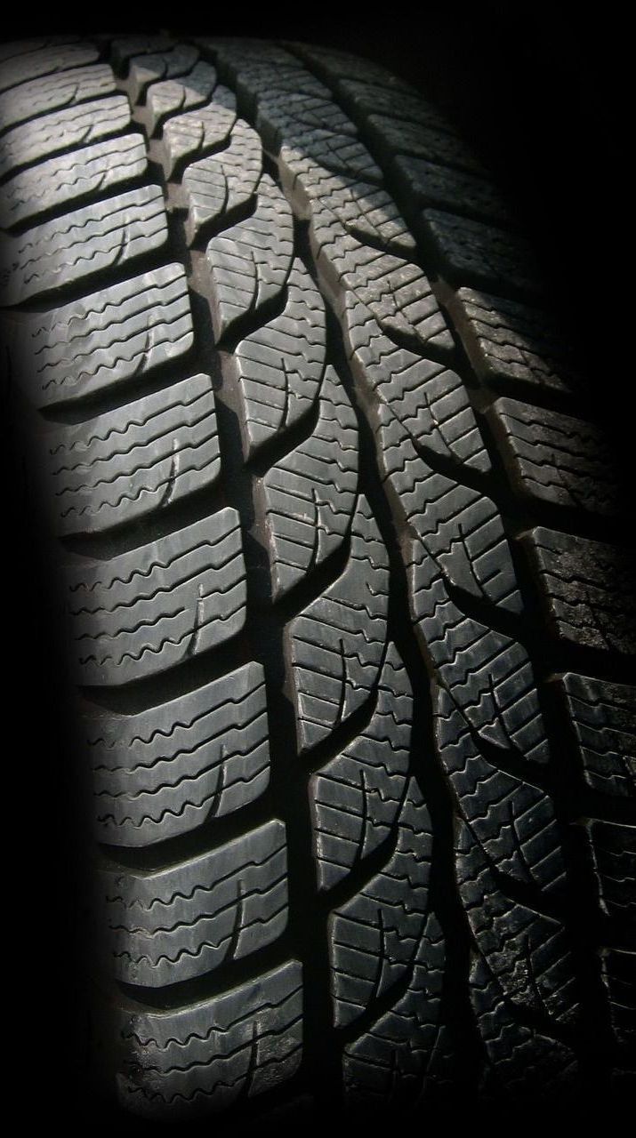 A close up of a tire on a black background
