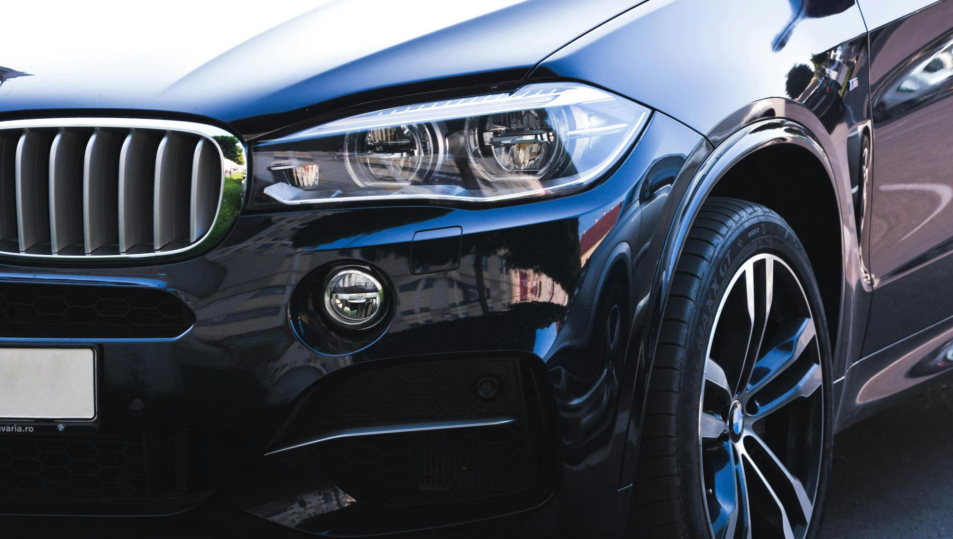 Black luxury SUV with silver rims and a chrome grill.