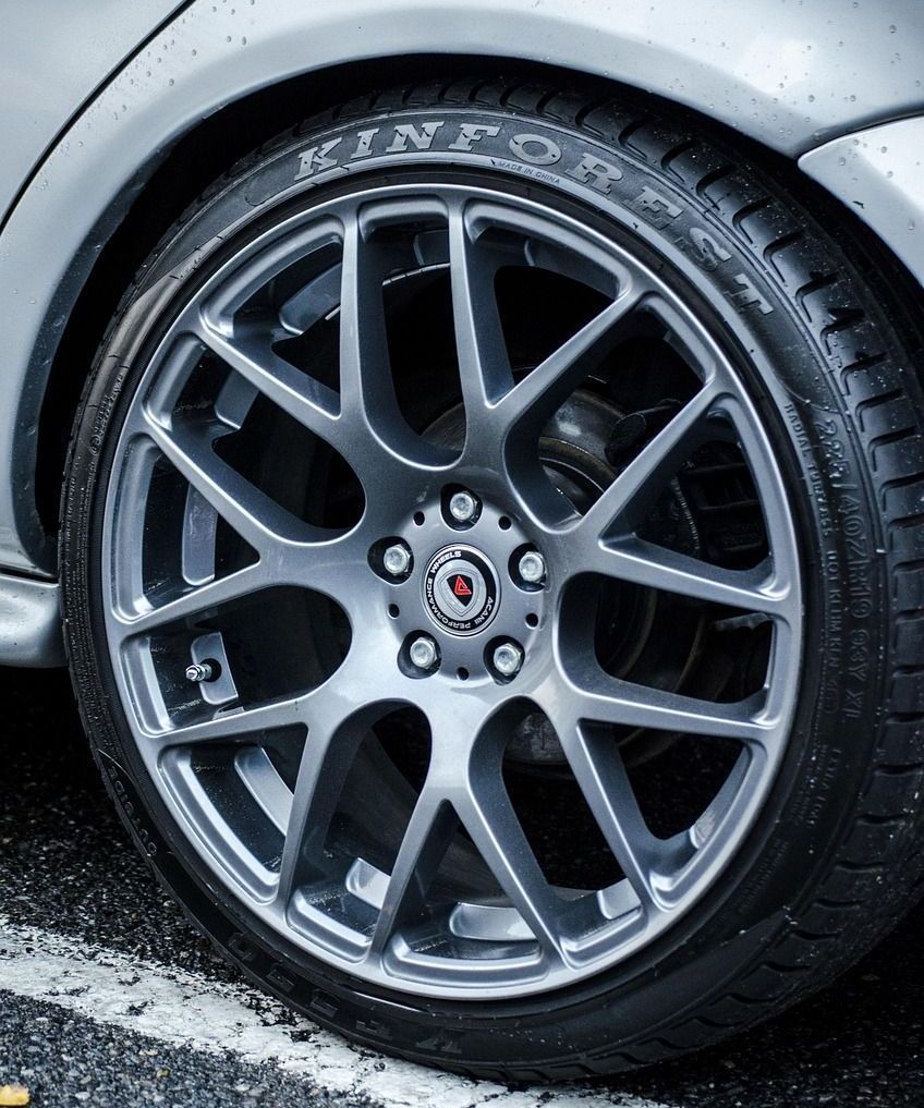 A close up of a car wheel with a tire on it
