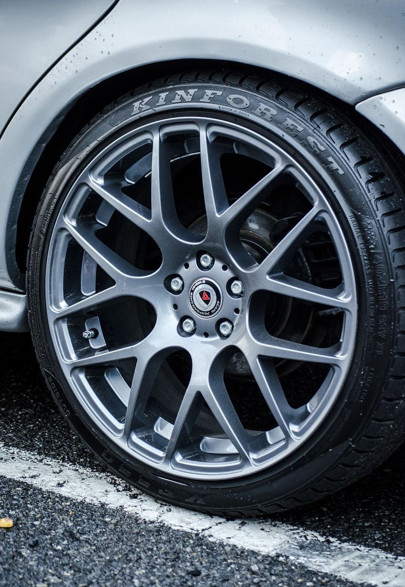 A close up of a car wheel with a tire on it