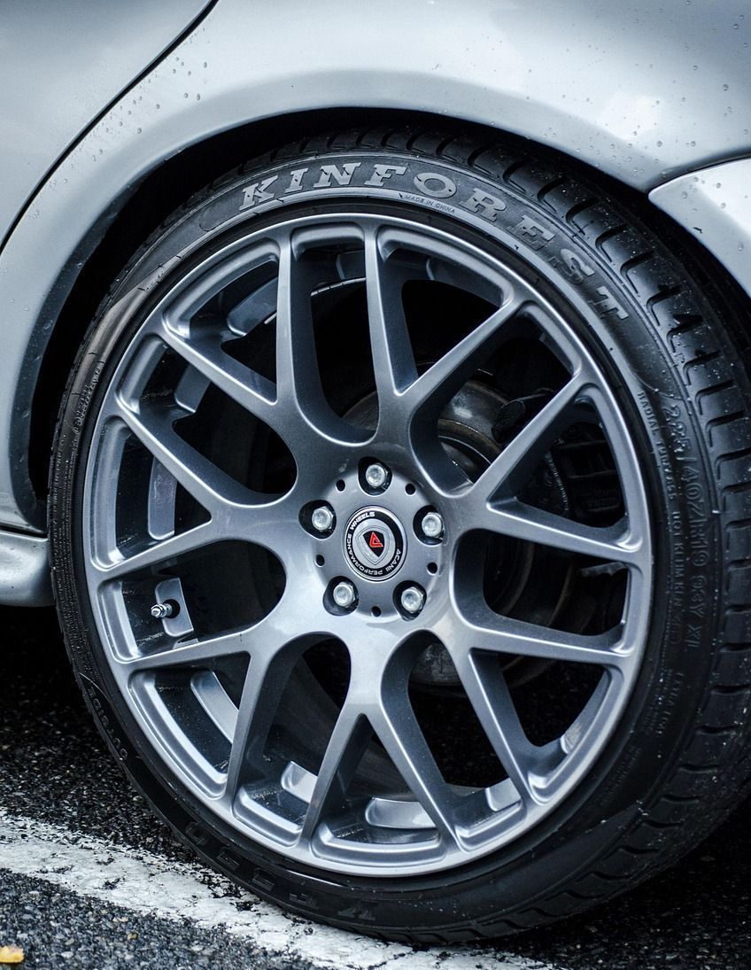 A close up of a car wheel with a tire on it.