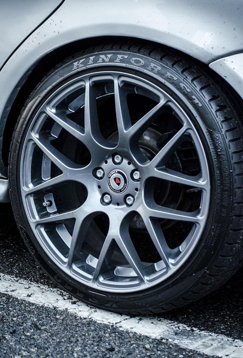 A close up of a car wheel with a tire on it.