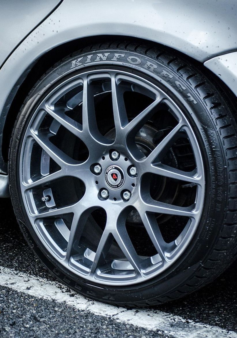 A close up of a car wheel with a tire on it.