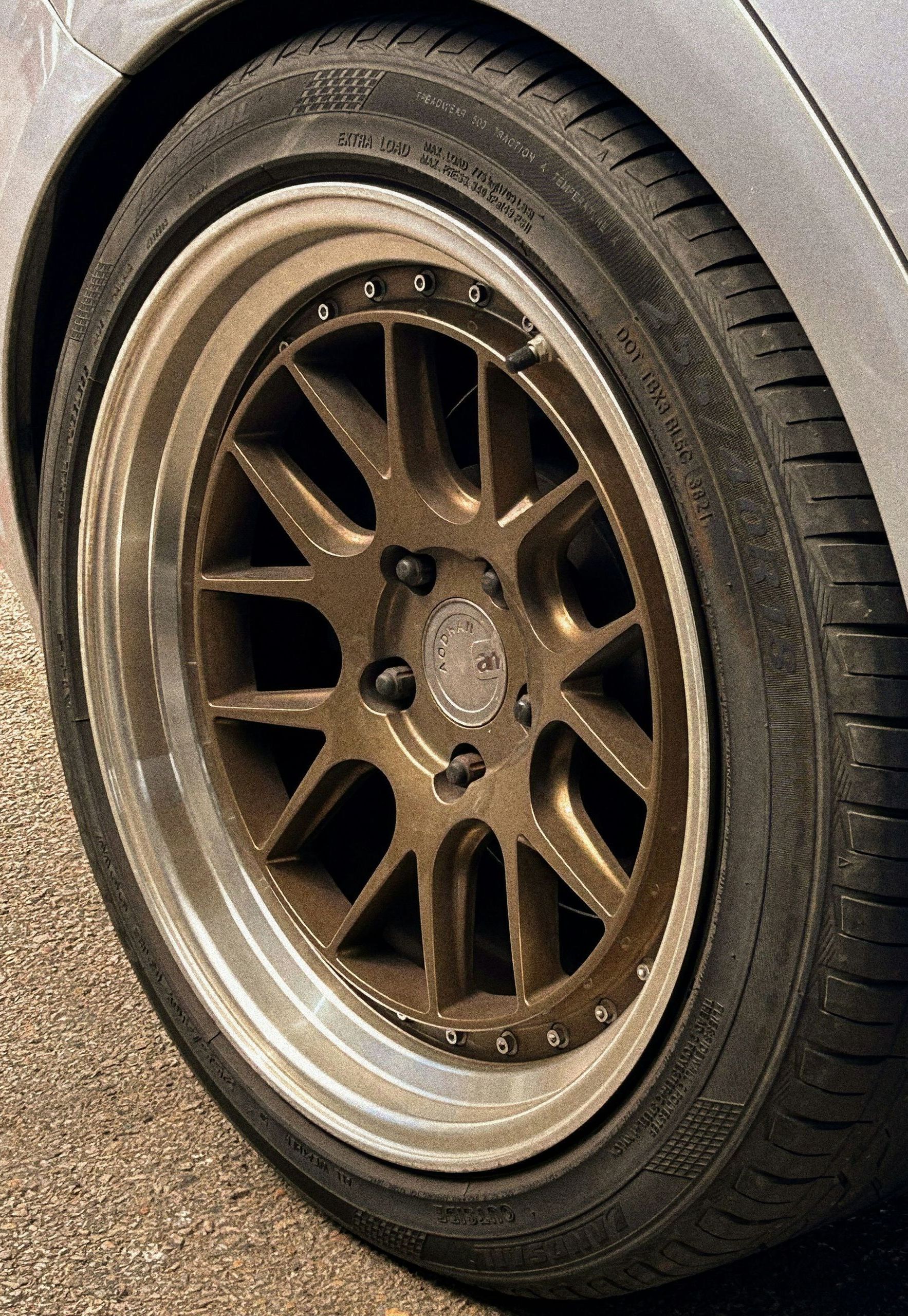 A close up of a car wheel with a tire on it