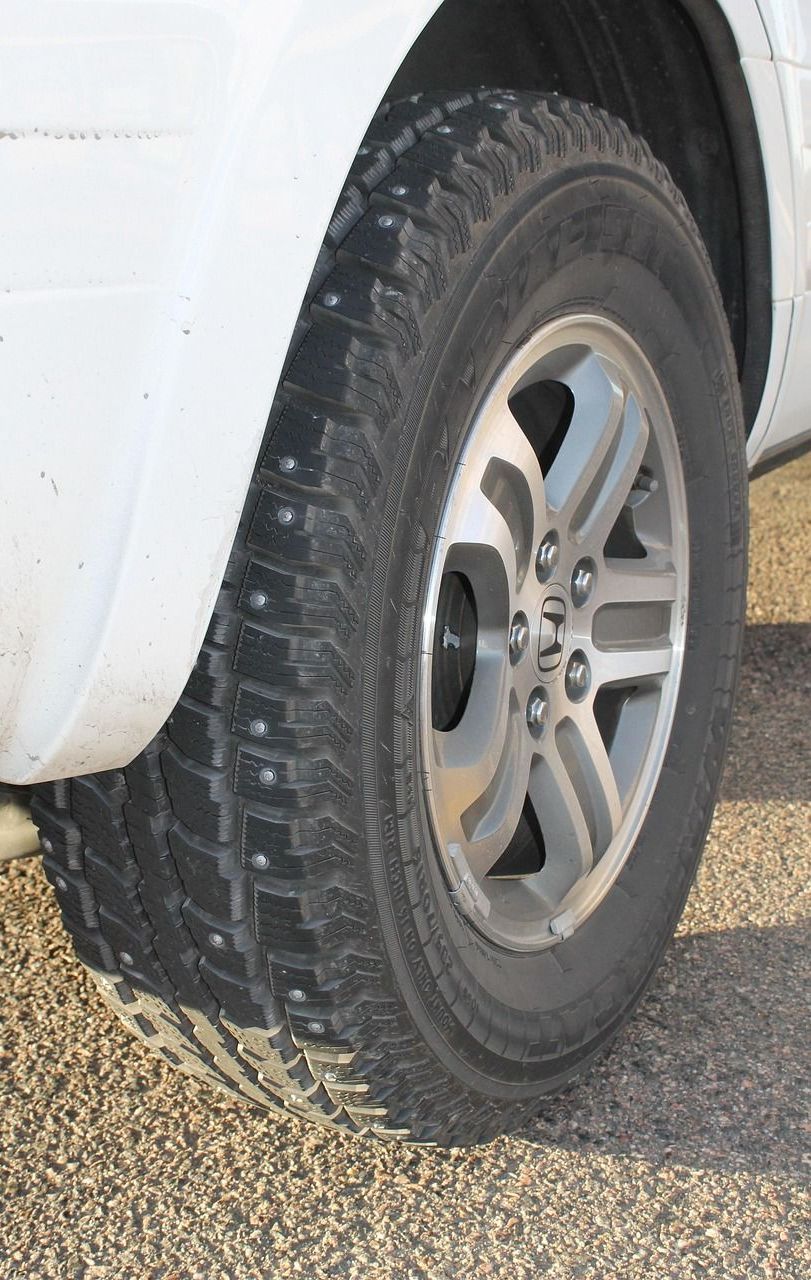 A close up of a tire on a white truck