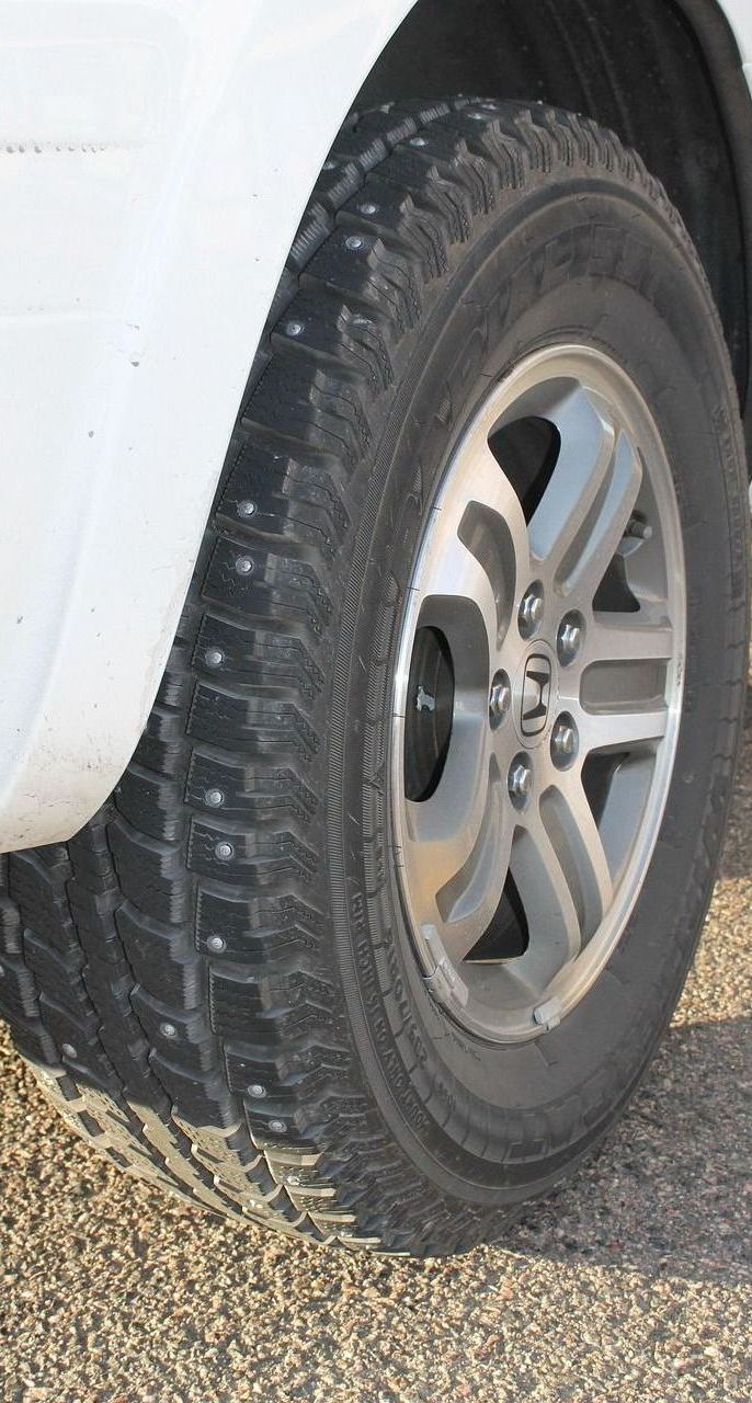 A close up of a tire on a white truck