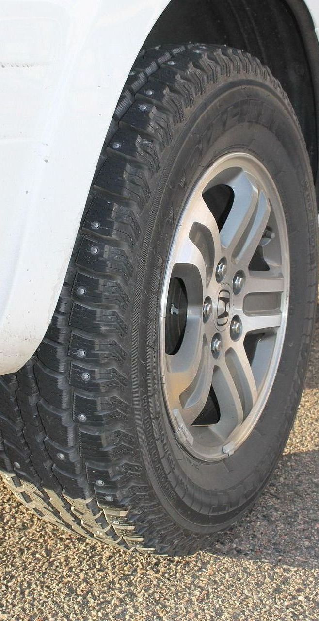 A close up of a tire on a white truck