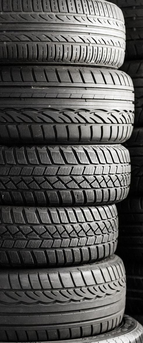 Stack of tires in black and white.