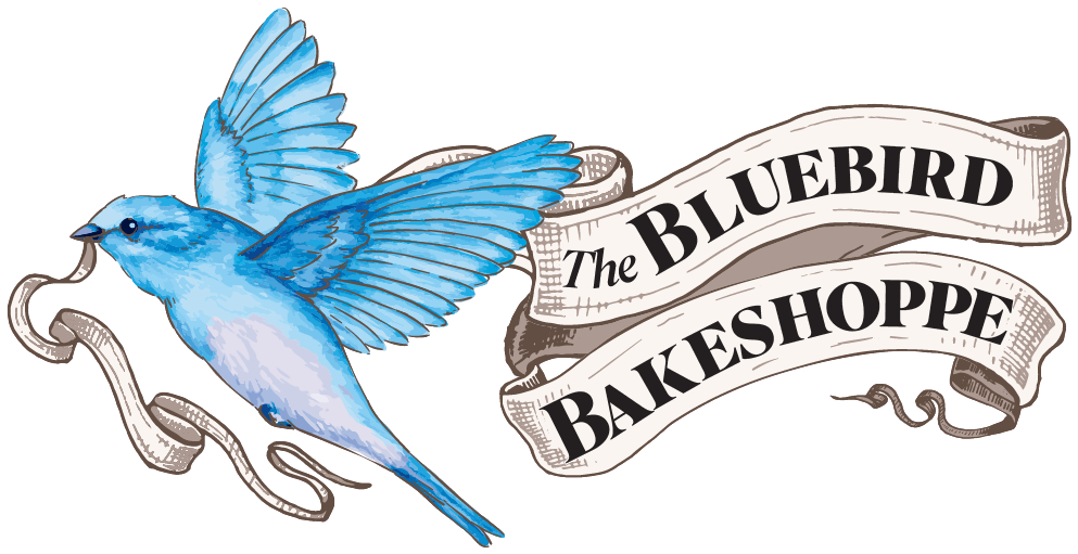 Bluebird with open wings holds ribbon; banner reads 