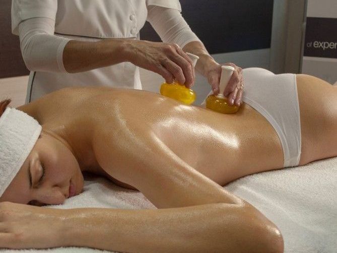 una donna sta ricevendo un massaggio con sale sulle spalle .