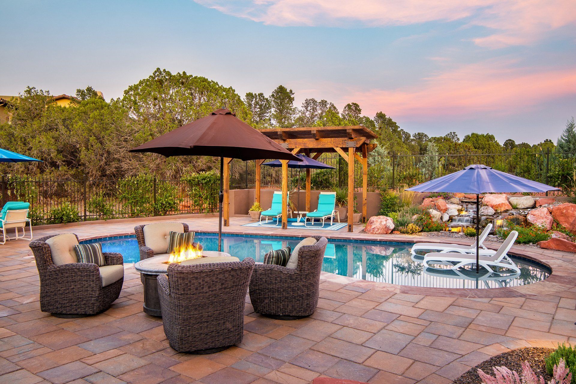 A large swimming pool with chairs and umbrellas around it