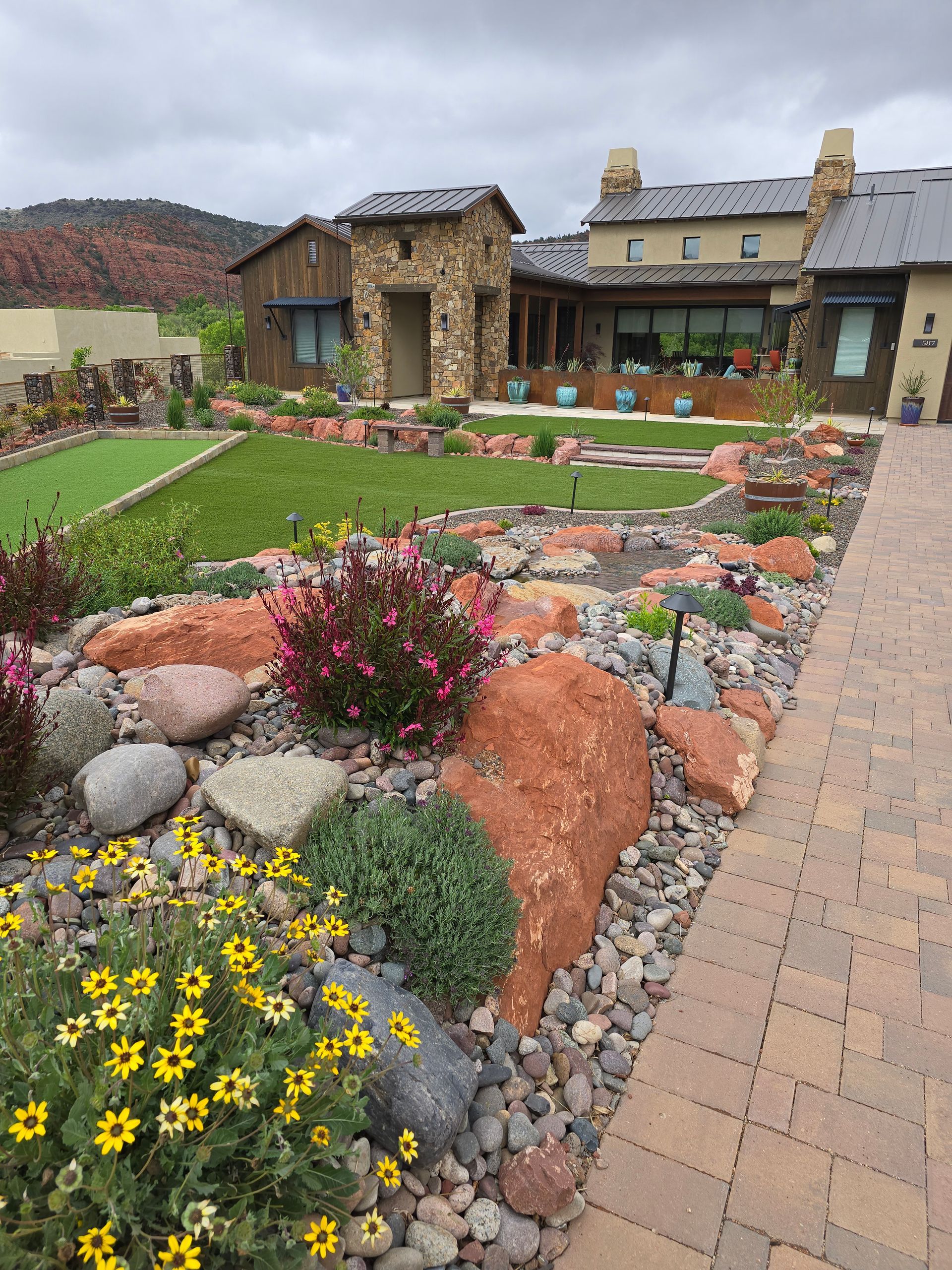 Green lawn and modern residential buildings under bright sunlight.
