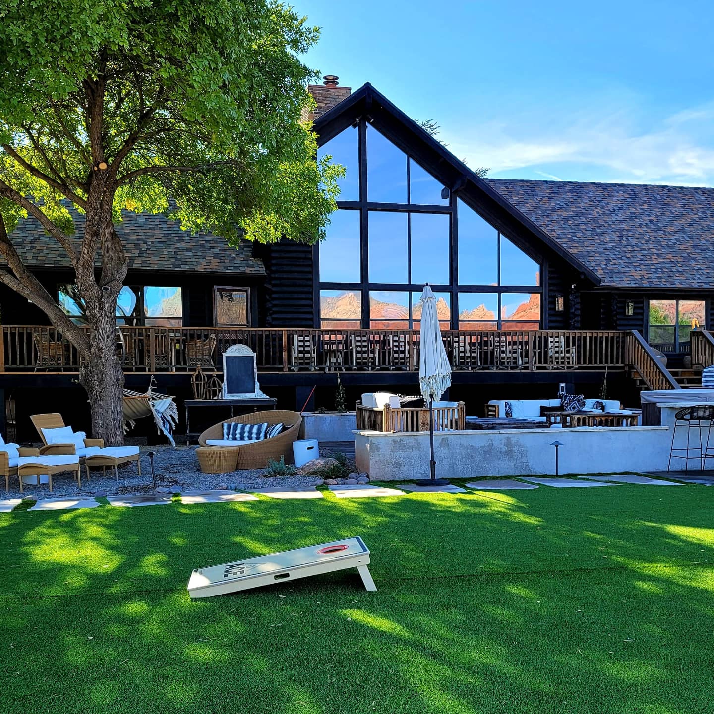 A large house with a lot of windows and a lawn in front of it