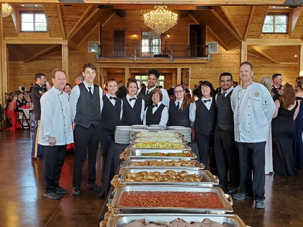 employees gathered around a buffet table