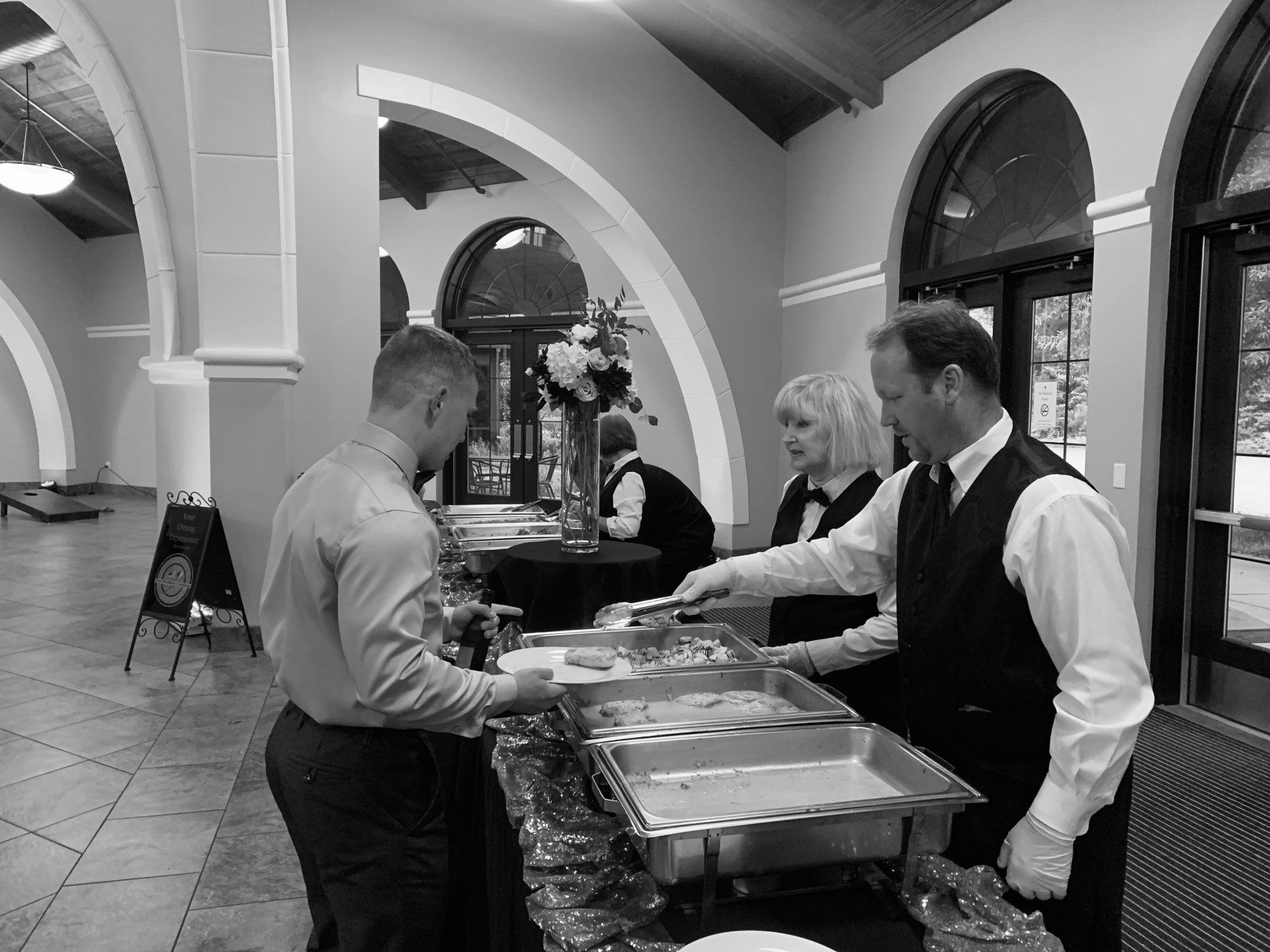 caterers serving man in buffet line