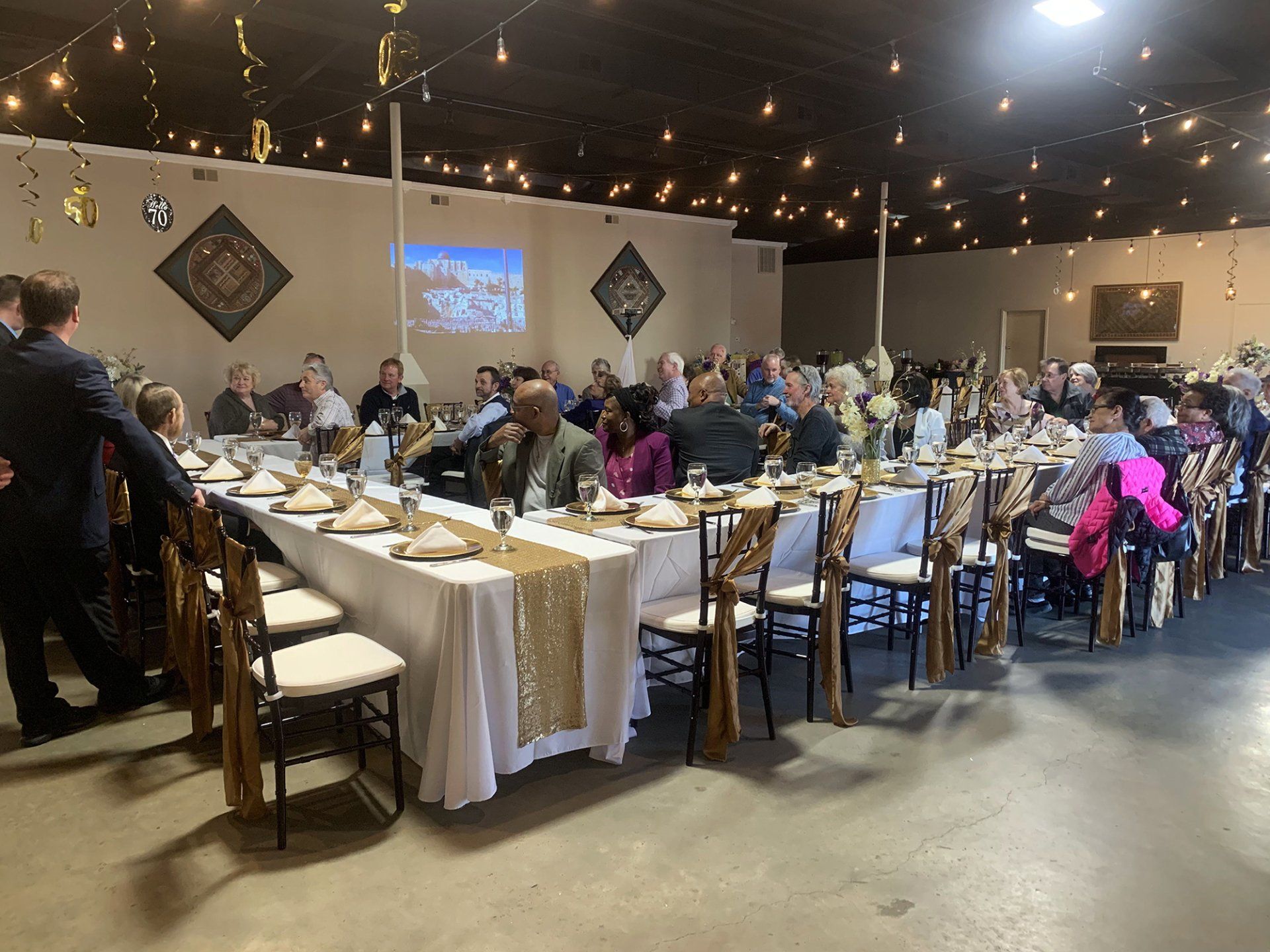 u shaped table filled with guests