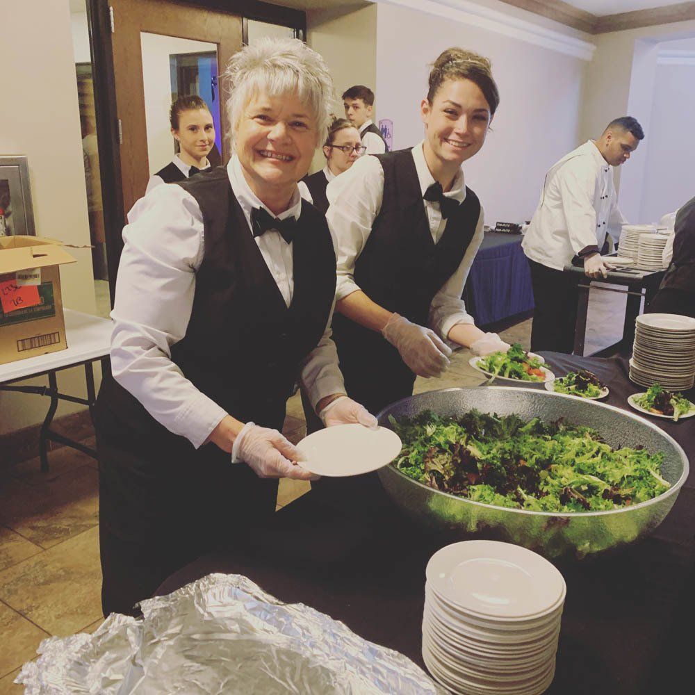 caterers ready to serve at a buffet