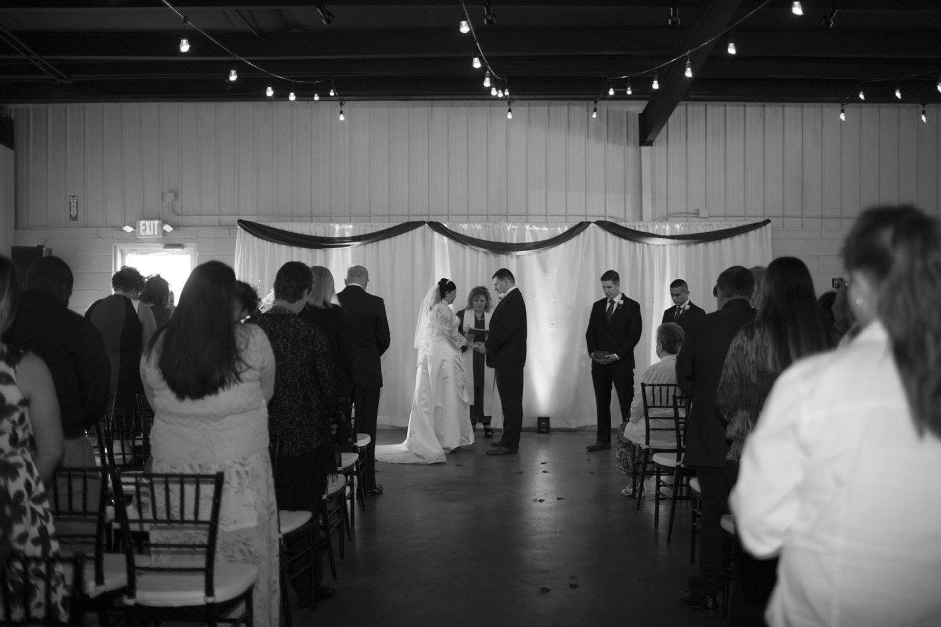wedding couple facing each other while guests look on